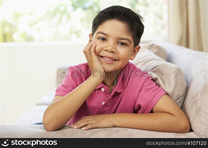 Young Boy Relaxing On Sofa At Home