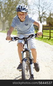 Young Boy Riding Bike Along Country Track