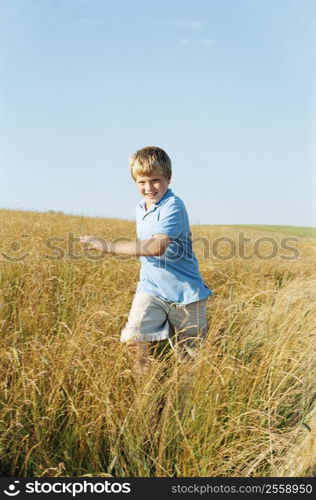 Young boy running outdoors smiling