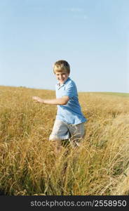 Young boy running outdoors smiling