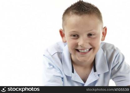 young boy smiling on white background with space for copy