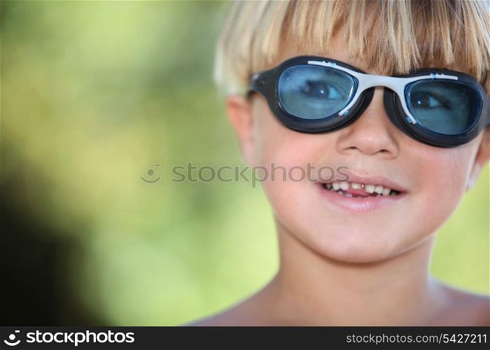 Young boy wearing swimming goggles