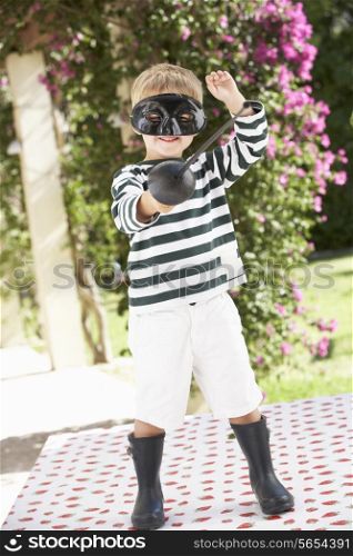 Young Boy Wearing Wellington Boots And Fancy Dress Costume