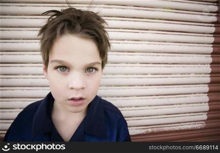 Young Boy with a Blank Stare and Green Eyes