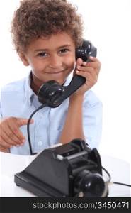 Young boy with an old-fashioned telephone