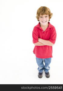 Young boy with arms crossed smiling