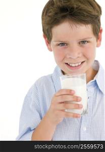 Young boy with glass of milk smiling
