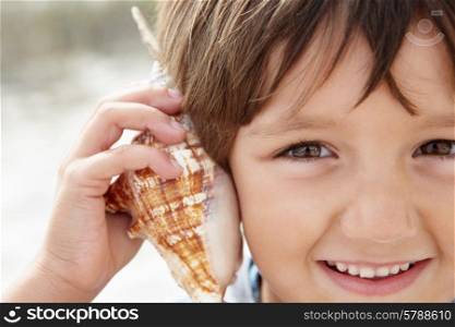 Young boy with seashell