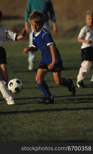 Young boys and girls playing football