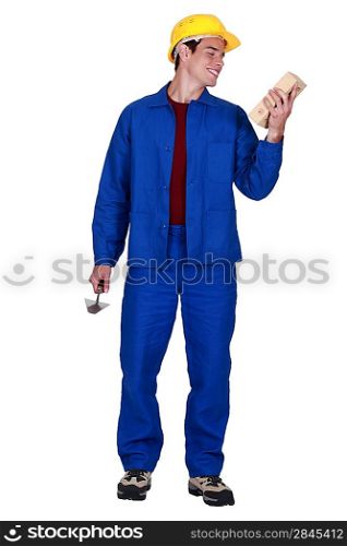 young bricklayer in jumpsuit