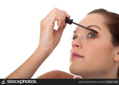 Young brown hair woman applying mascara on white background