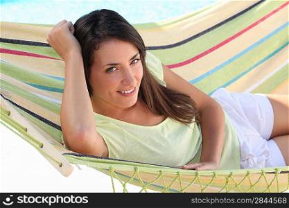 Young brown-haired woman laid in hammock