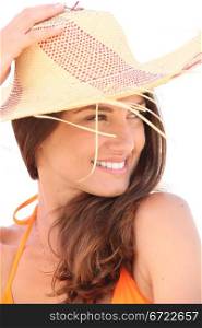 Young brown-haired woman with straw hat