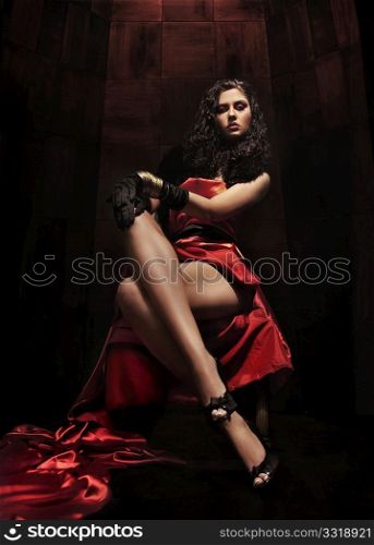 Young brunette beauty over dark mysterious background