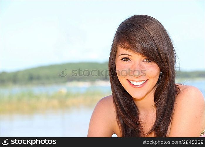 Young brunette by lake