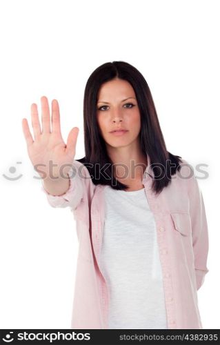 Young brunette girl making stop sign on a white background