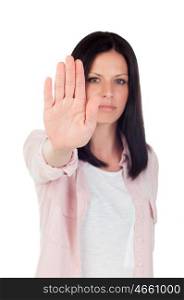 Young brunette girl making stop sign on a white background. Focus on hand