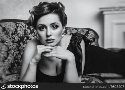 young brunette girl model and actress on the sofa closeup, black and white