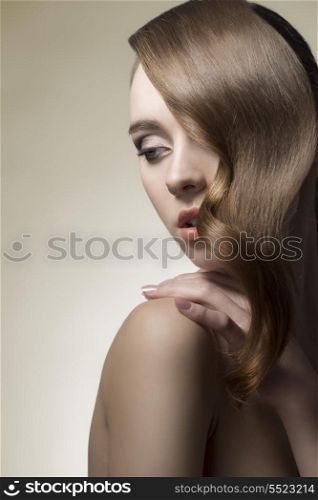 young brunette girl posing in close-up shoot with sensual pose, cute make-up and shiny wavy hair