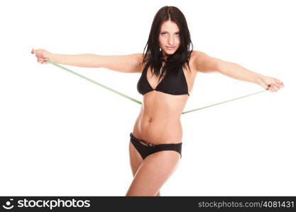 young brunette girl very tiny body in bikini with measuring her waistline a tape