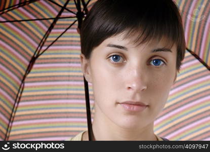 young brunette girl with umbrella in colors