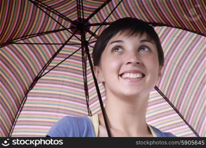 young brunette girl with umbrella in colors