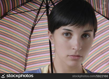 young brunette girl with umbrella, studio picture
