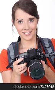 Young brunette holding expensive camera