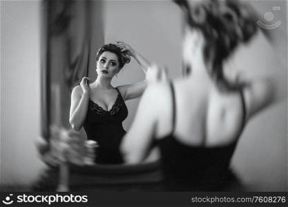 young brunette model girl and actress in front of a mirror, black and white