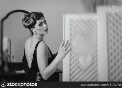 young brunette model girl and actress near the screen, black and white