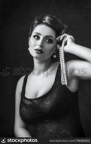 young brunette model girl and actress with pearl beads, black and white