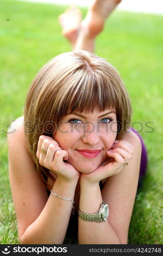 young brunette teenager girl on fresh spring meadow