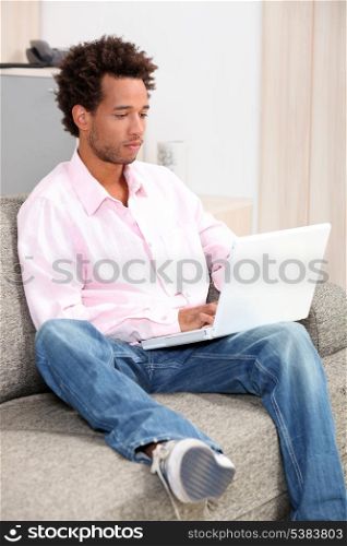 Young brunette with computer on knees