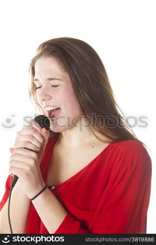 young brunette with microphone in studio against white background