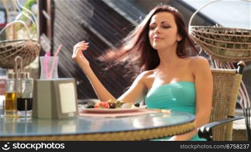 young brunette Woman has dinner In coffee shop
