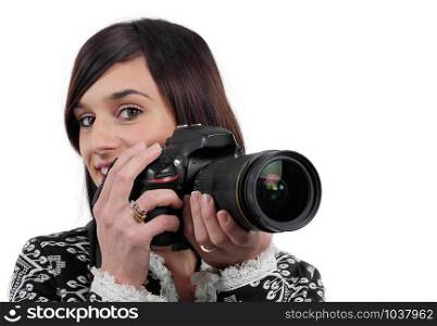 young brunette woman holding slr camera isolated on white background