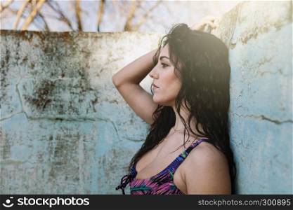 Young brunette woman in an old empty pool