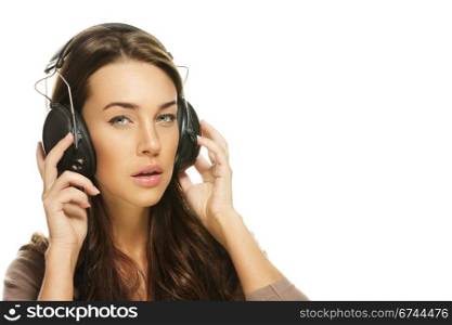 young brunette woman listening to music. young brunette woman listening to music on white background