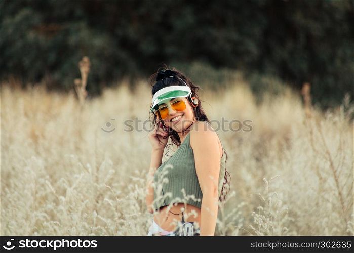Young brunette woman listens to music in old cassette
