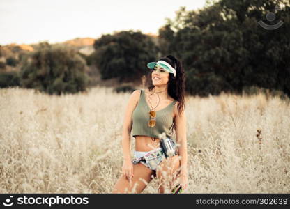 Young brunette woman listens to music in old cassette