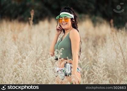 Young brunette woman listens to music in old cassette