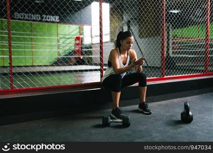 Young brunette woman resting in the gym