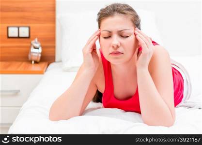 young brunette woman suffering from migraine