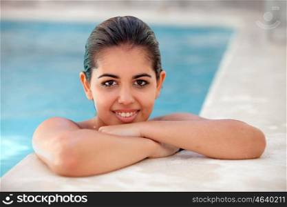 Young brunette woman wet in the pool. Summer time and relax