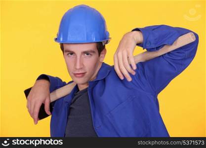 Young builder posing with sledge-hammer