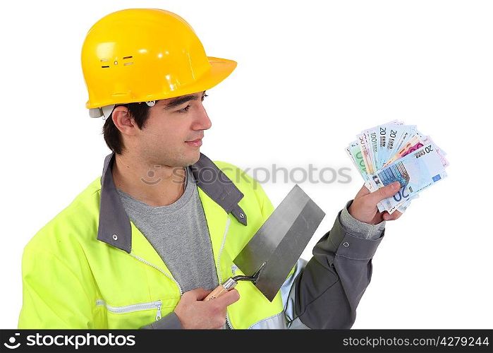 Young builder with a handful of cash