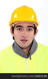 Young builder with look of shock on his face