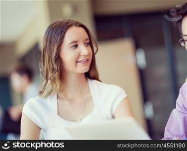 Young busines woman in office. Young busines woman sitting and working in office