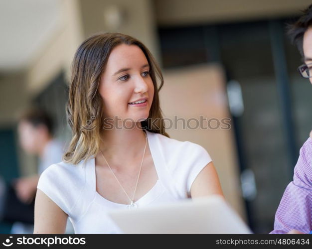 Young busines woman in office. Young busines woman sitting and working in office