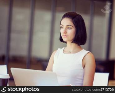 Young busines woman with notebook. Young busines woman sitting and working with notebook